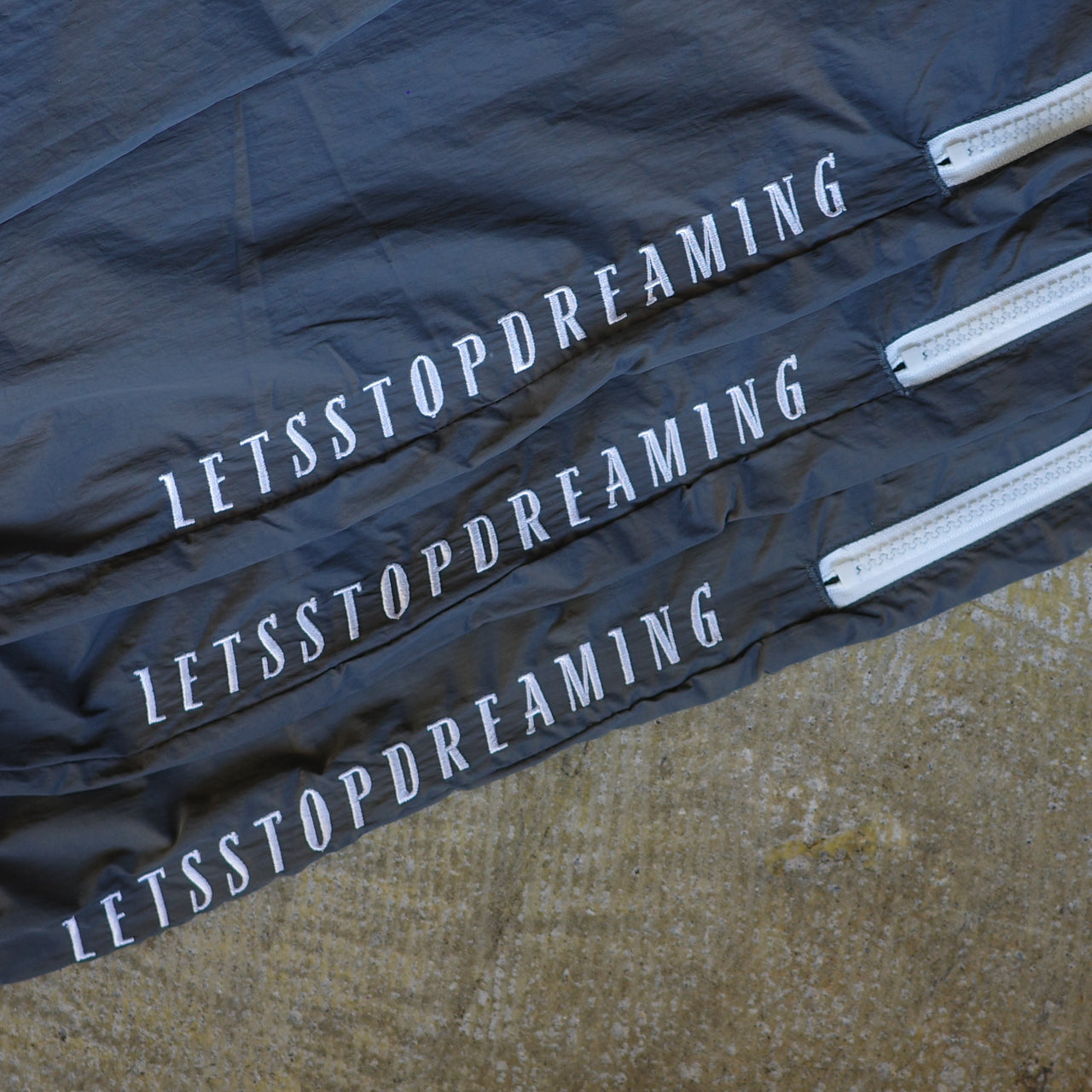 ANORAK CLUB  -LET'S STOP DREAMING-  NYLON TRACK PANTS  アノラッククラブ